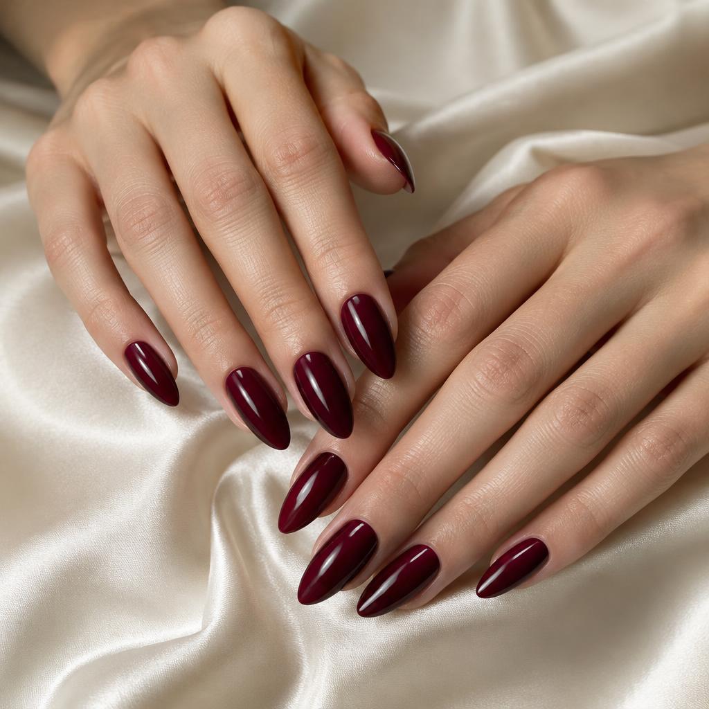Glossy burgundy almond manicure